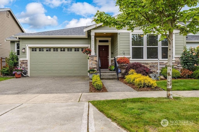 view of front of property with a garage and a front lawn