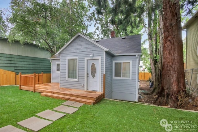 bungalow-style house featuring a wooden deck and a front yard