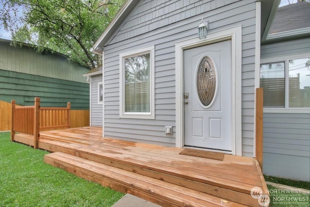 view of exterior entry with a deck