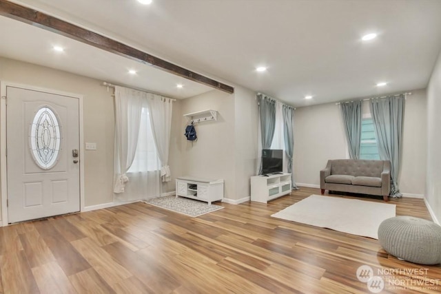 entryway with beam ceiling and hardwood / wood-style floors