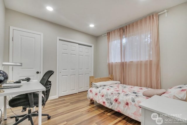 bedroom featuring light hardwood / wood-style floors and a closet