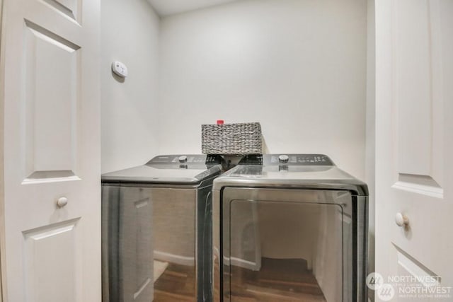 laundry room featuring wood-type flooring and washer and dryer