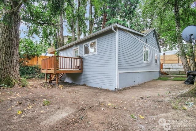 view of home's exterior featuring a wooden deck