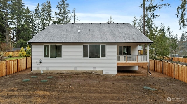 back of house featuring crawl space, a fenced backyard, and roof with shingles