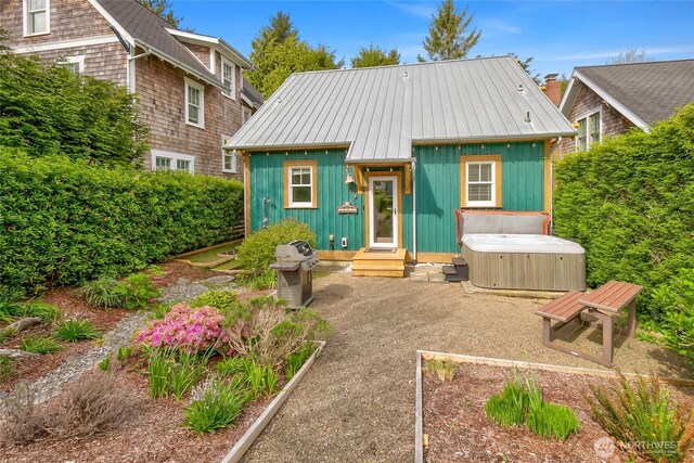18 Primrose Ln, Pacific Beach, WA 98571 - rear view of house featuring board and batten siding and a hot tub