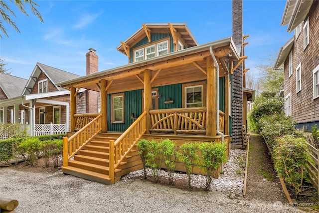18 Primrose Ln, Pacific Beach, WA 98571 - view of front of house with covered porch, board and batten siding, and a chimney