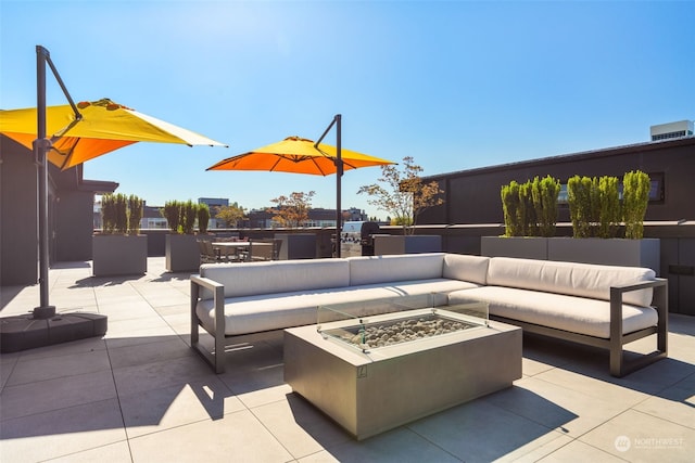 view of patio / terrace featuring an outdoor living space with a fire pit