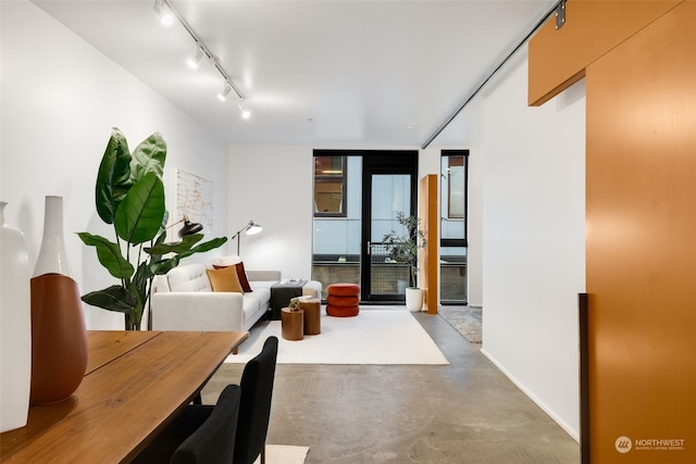 interior space featuring track lighting, concrete floors, and expansive windows