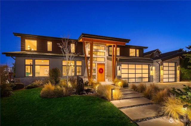 prairie-style house with a garage and a front yard