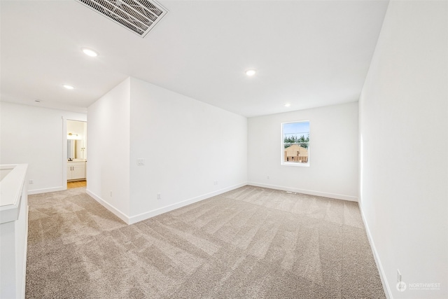 unfurnished room with light carpet