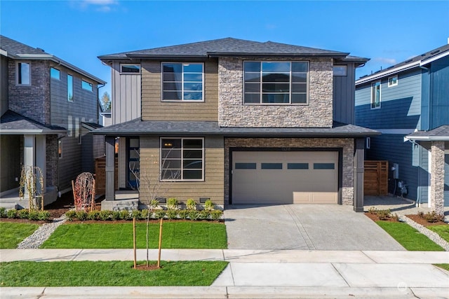 view of front of property featuring a garage and a front lawn