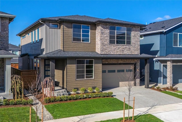 view of front of home with a garage and a front lawn