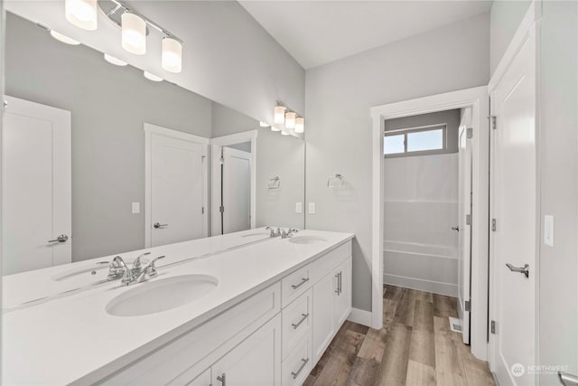 bathroom featuring vanity, wood-type flooring, and shower / bath combination