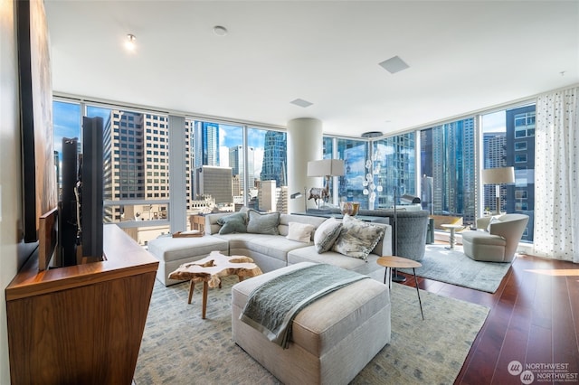 living room featuring wood-type flooring and floor to ceiling windows