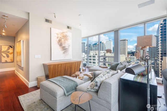 interior space with track lighting, dark hardwood / wood-style floors, and expansive windows