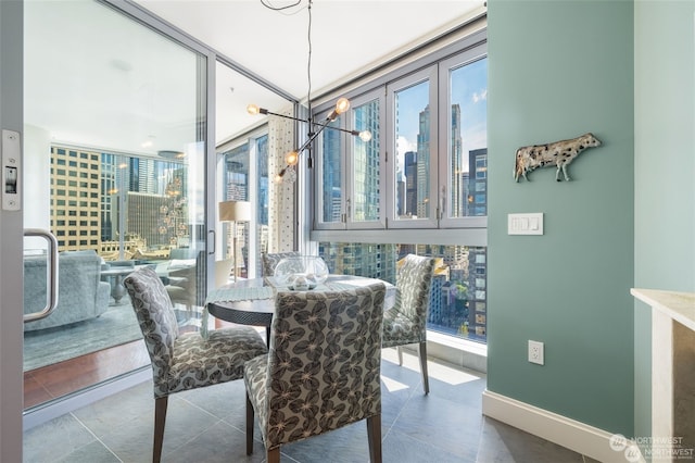 tiled dining area featuring a chandelier