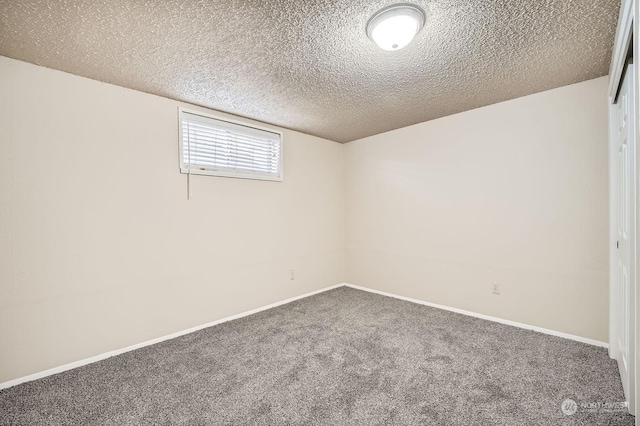 basement featuring carpet flooring and a textured ceiling