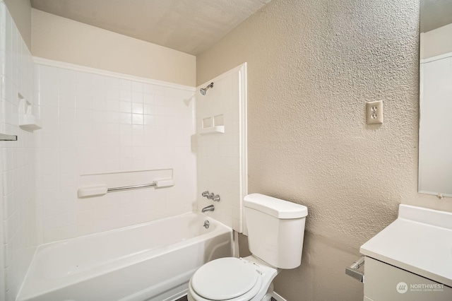 full bathroom featuring tiled shower / bath, vanity, and toilet