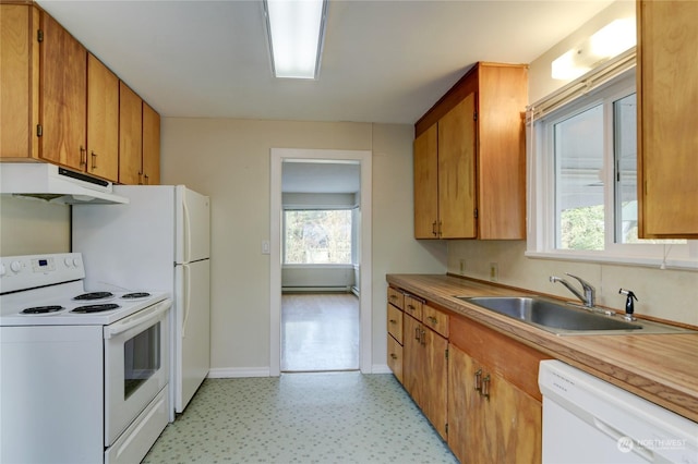 kitchen featuring white appliances, a baseboard radiator, and sink