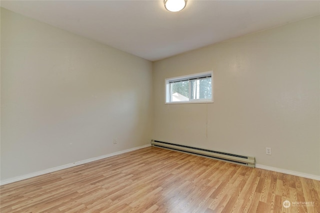 empty room with a baseboard radiator and light wood-type flooring