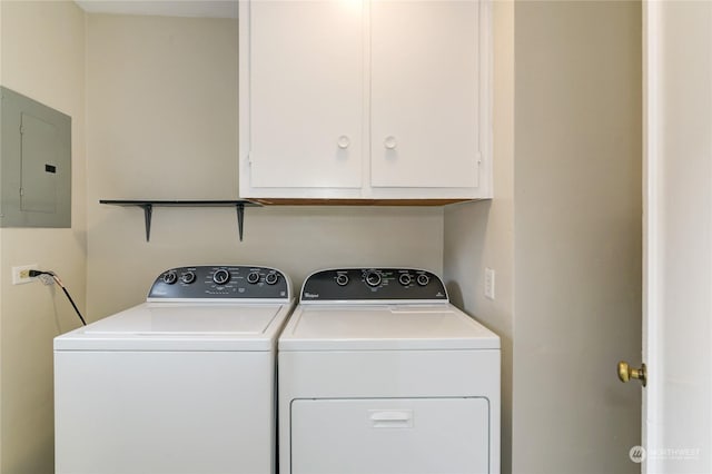 washroom featuring cabinets, separate washer and dryer, and electric panel