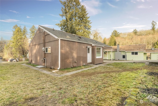 rear view of property with a yard