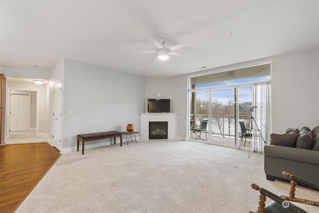 living room with ceiling fan and carpet floors