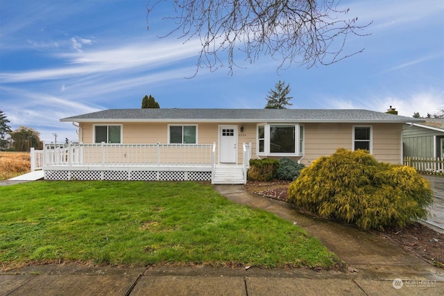 ranch-style home featuring a deck and a front lawn