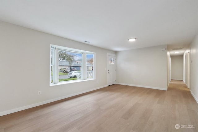 unfurnished room featuring light hardwood / wood-style floors