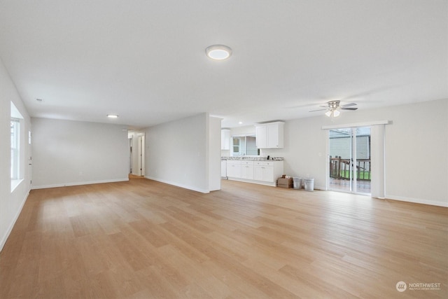 unfurnished living room with light hardwood / wood-style flooring and ceiling fan