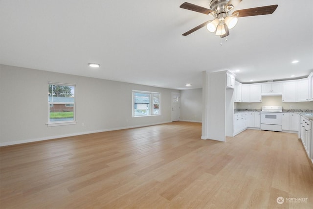 unfurnished living room with ceiling fan, light hardwood / wood-style flooring, and a wealth of natural light