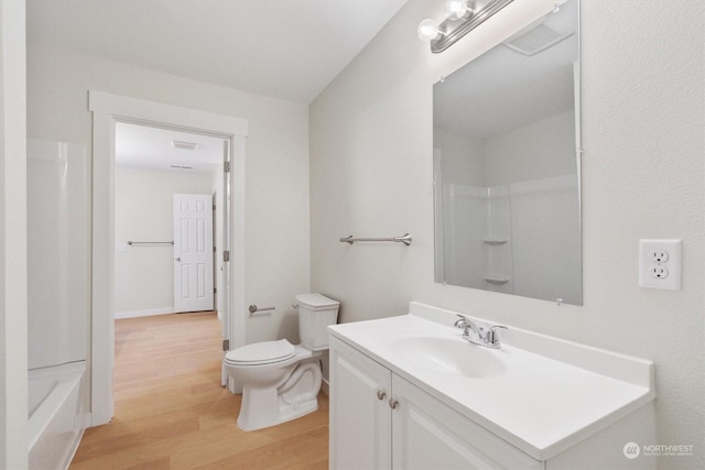 bathroom featuring vanity, hardwood / wood-style floors, and toilet