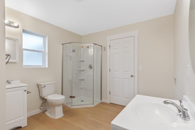 bathroom with vanity, toilet, hardwood / wood-style floors, and walk in shower