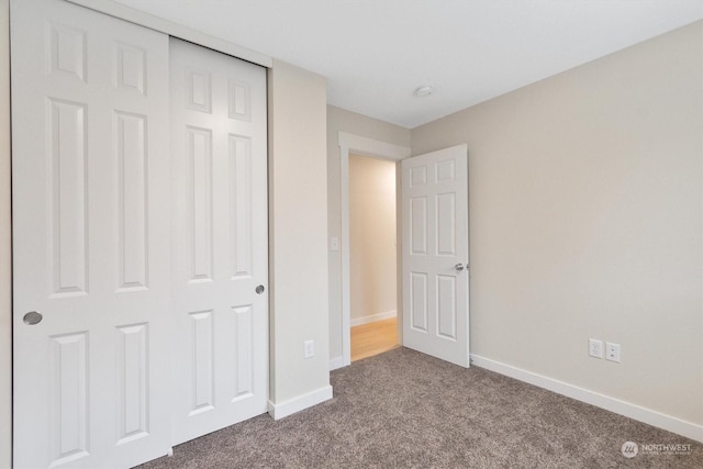 unfurnished bedroom featuring a closet and carpet flooring