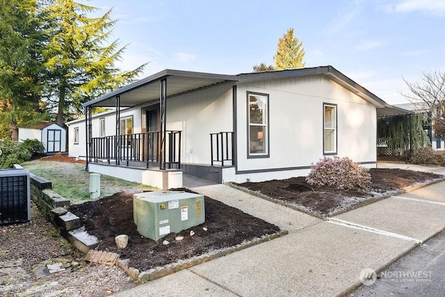 view of side of property with central AC and covered porch