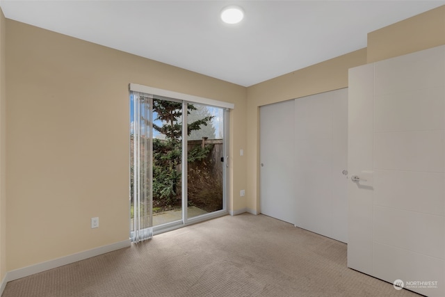 unfurnished room featuring light colored carpet