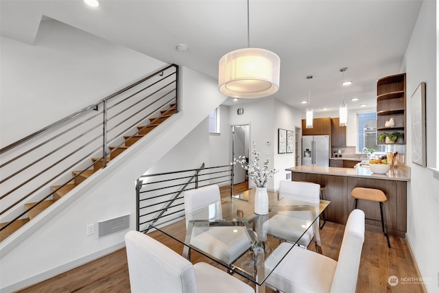 dining area with hardwood / wood-style floors