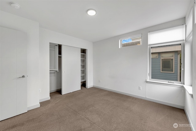 unfurnished bedroom featuring carpet floors and a closet