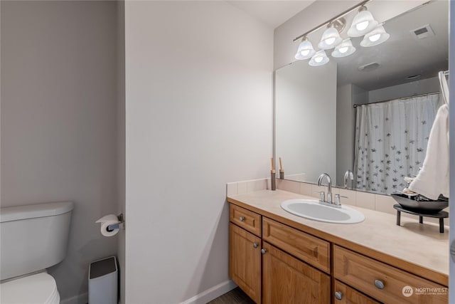 bathroom with a shower with curtain, vanity, and toilet