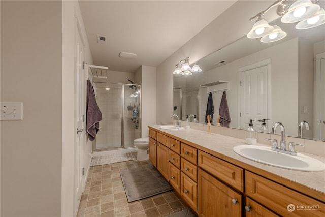 bathroom with vanity, toilet, and walk in shower