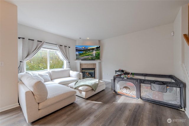 living room featuring hardwood / wood-style floors and a tile fireplace