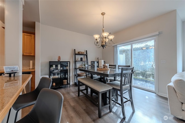 dining space with a notable chandelier and dark hardwood / wood-style flooring