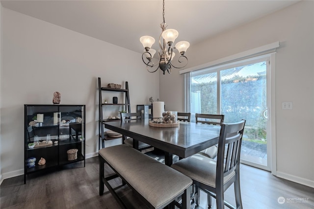 dining area featuring an inviting chandelier and dark hardwood / wood-style floors