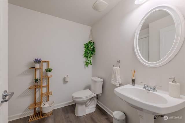 bathroom featuring hardwood / wood-style flooring, toilet, and sink