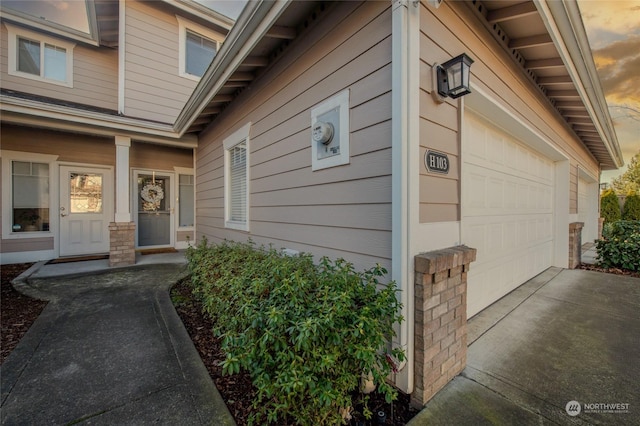 exterior entry at dusk with a garage