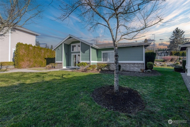 view of front of home with a yard