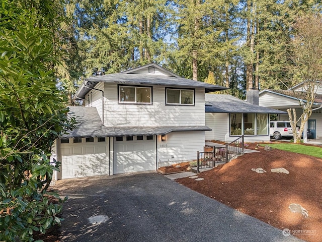 tri-level home featuring a carport and a garage