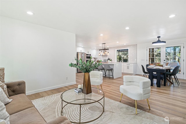 living room with light hardwood / wood-style floors and french doors