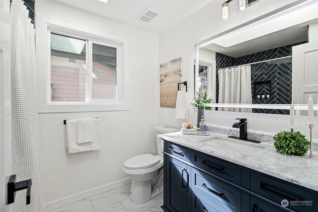 bathroom featuring vanity, toilet, and curtained shower