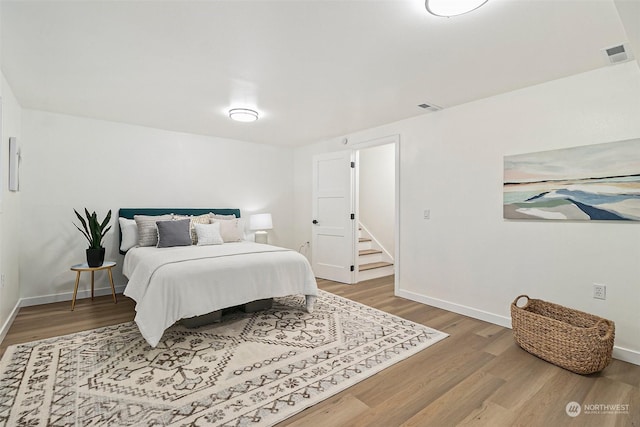 bedroom with hardwood / wood-style floors